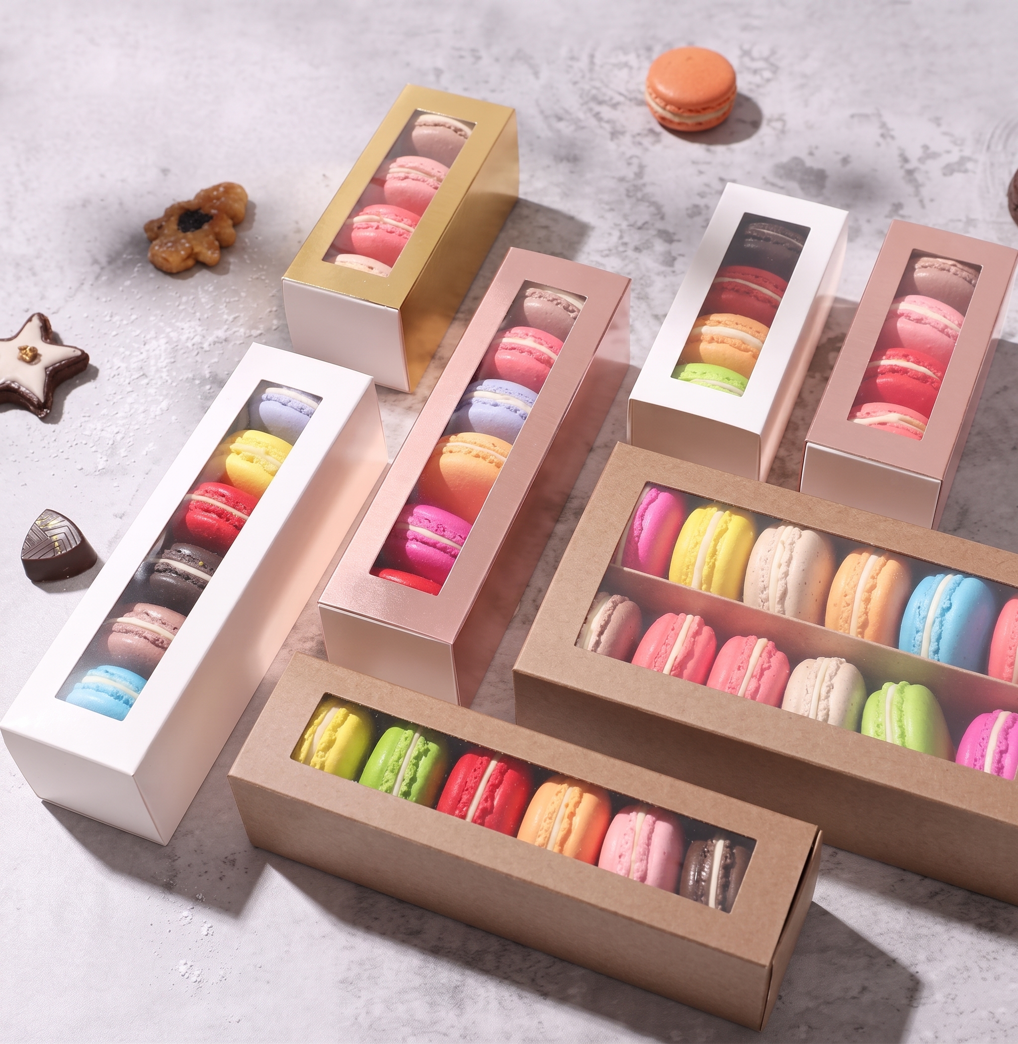 Assorted French macarons in pastel colors arranged in an open gift box